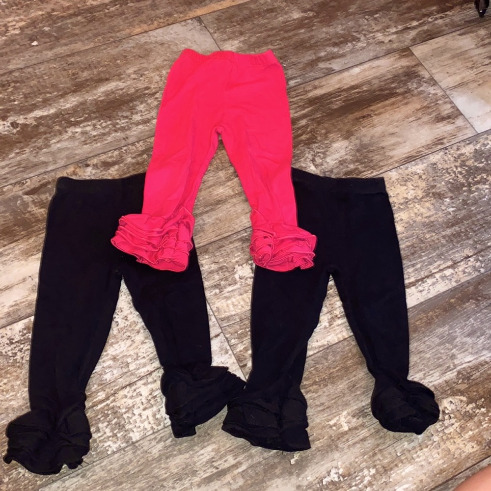 set of three pairs of leggings with ruffles at the bottom